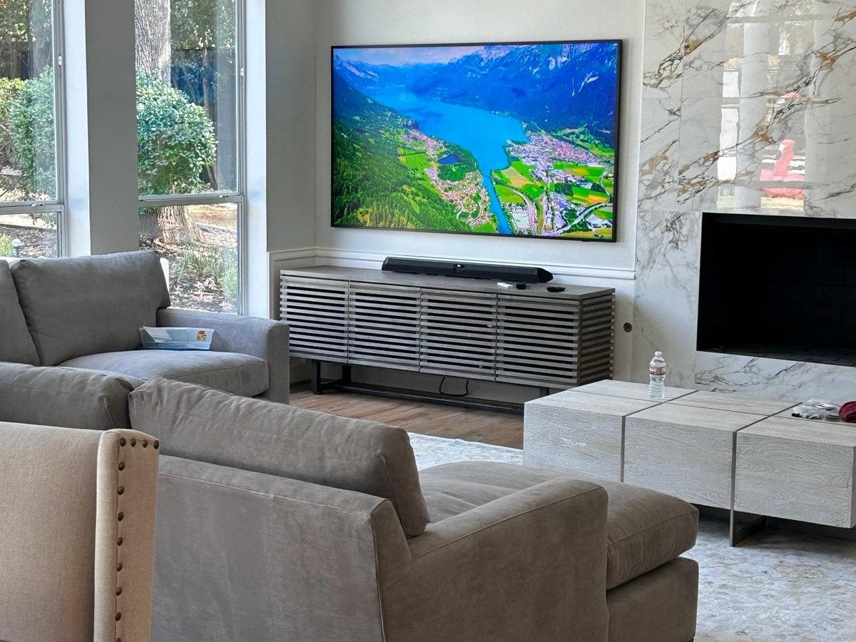 TV mounted on a wall with hidden wiring in a luxury living room